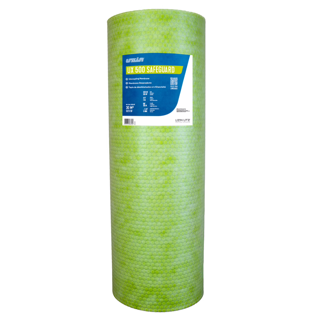 UZIN UX 500 Safeguard Dummy FINAL LABEL DESIGN A tall cylindrical roll of light green dimpled underlayment material photographed upright on a white background. A rectangular blue, white and yellow product label near the top reads 'UX 500 SAFEGUARD' and shows the UZIN brand logo, a QR code and blocks of technical text; the membrane surface displays a repeating circular dimple pattern. Studio-style product shot emphasizing the roll's color, textured surface and label details; intended as an uncoupling and waterproofing membrane for floor installations.