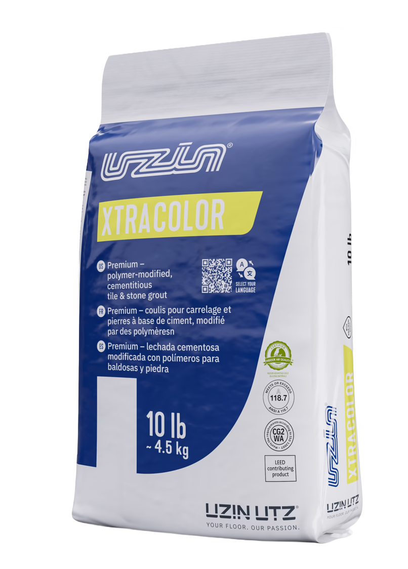 UZIN_Dummy_XtraColor_NoColor Photograph of a standing 10 lb (≈4.5 kg) bag of XTRACOLOR tile and stone grout by UZIN LUTZ. The packaging is primarily blue and white with a yellow accent strip showing the product name XTRACOLOR; the brand logo appears at the top and bottom. The front lists product details in multiple languages, including 'premium — polymer-modified, cementitious tile & stone grout', a QR code, certification icons and the weight. The bag sits on a plain white background with the side seam and resealable top visible.